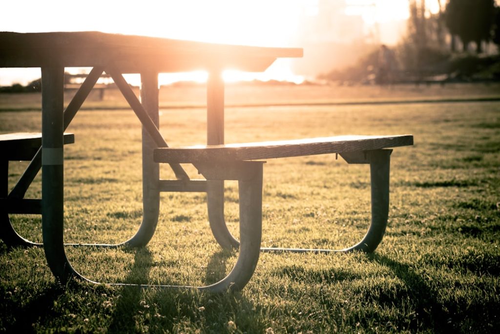 grey-picnic-table-on-grass-field-during-sunset-amsbil7-mks